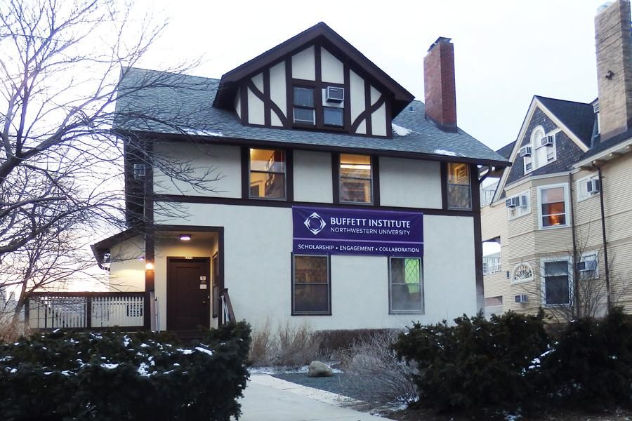 A white house with a purple sign that reads “BUFFETT INSTITUTE.”