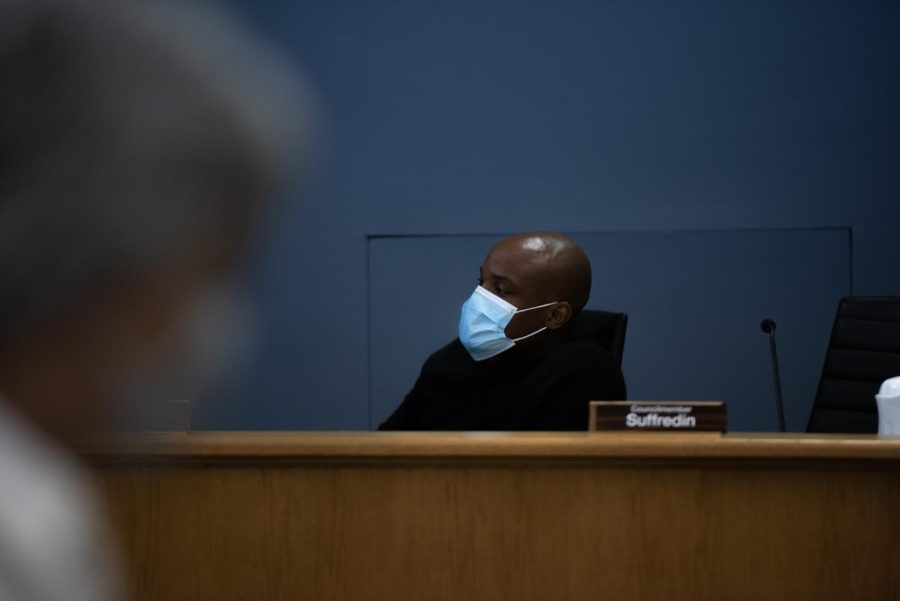 Ald. Bobby Burns (5th) leans back in his chair. He is masked and against a blue background.