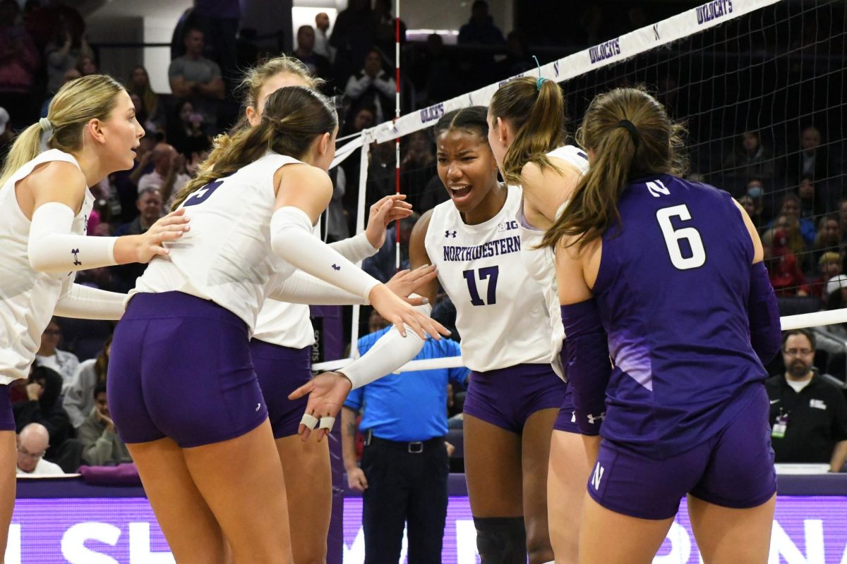 Northwestern volleyball players celebrate winning a point. Grand Canyon Universitys Tim Nollan has been named the Wildcats next head coach.
