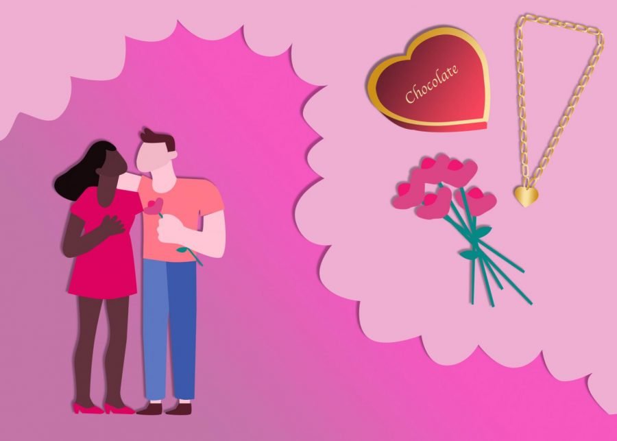 A couple enjoys Valentine’s Day together in front of a pink background with pink flowers, a chocolate box and a necklace.